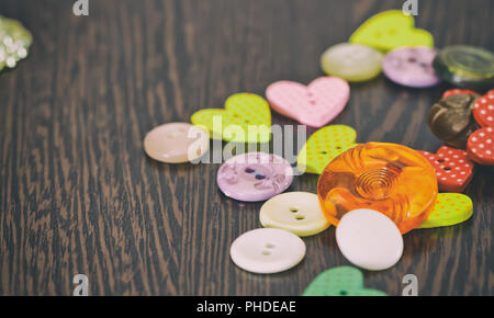 Buttons dark tones are on the table Stock Photo