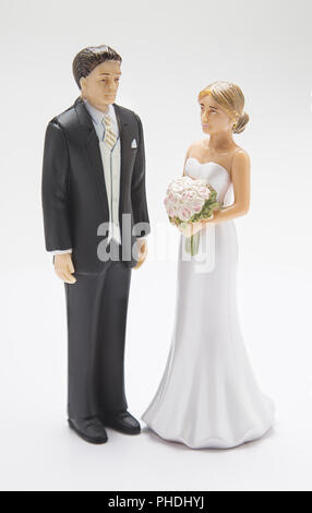 Groom and bride cake topper on a white background Stock Photo