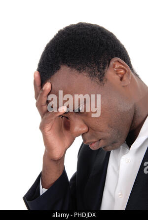 Depressed African man with hand on face Stock Photo