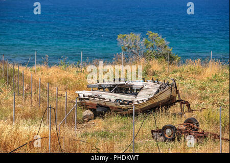 Old broken boat on seashore Stock Photo