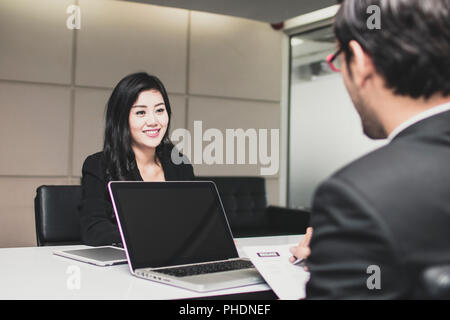 Asian beautiful  young female candidate  presents  herself to interviewer with big smiled for getting job in office Stock Photo