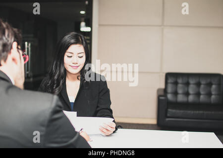 Asian beautiful  young female candidate  presents  herself to interviewer with big smiled for getting job in office. Stock Photo