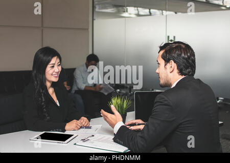 Asian beautiful  young female candidate  presents  herself to interviewer with big smiled for getting job in office. Stock Photo