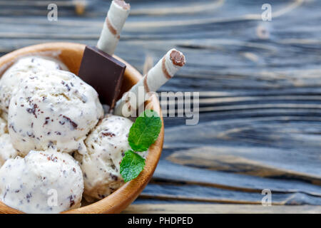 Creamy ice cream with chocolate crumb and wafer rolls. Stock Photo