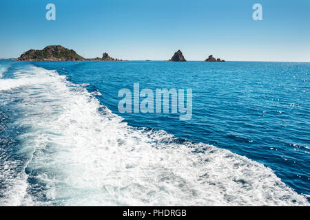 Waves on blue sea behind the boat Stock Photo