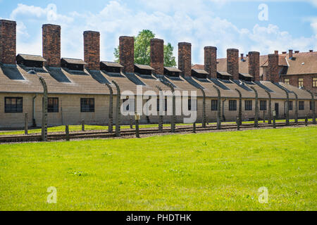 Electric fence in former Nazi concentration camp Stock Photo