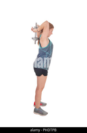 Young woman lifting dumbbell's over her head Stock Photo