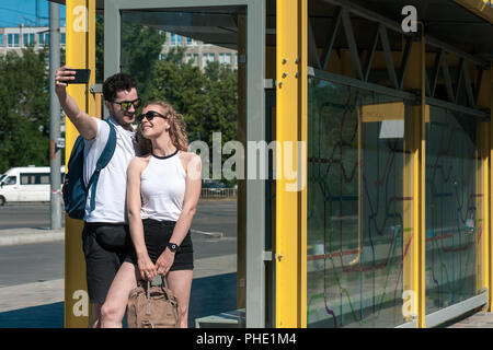 Handsome man taking selfie with pretty woman. Relationship concept with nice boyfriend and girlfriend. Stock Photo