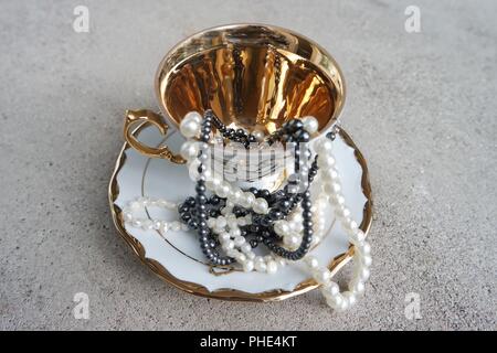 Pearls in golden cup Stock Photo