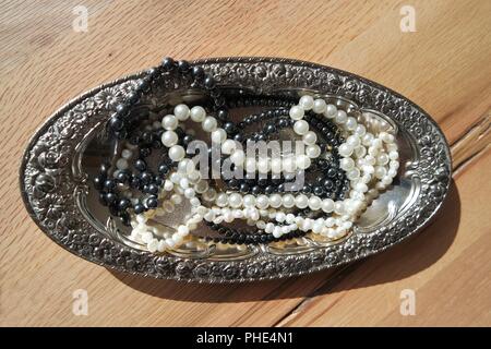 Pearls on silver tray Stock Photo
