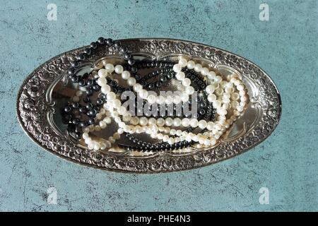Pearls on silver tray Stock Photo