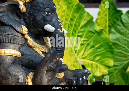Statue Ganesha in a garden of balinese house Stock Photo