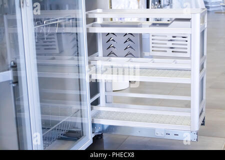 Organizer for utensils. Shelf for plates. Bar shelf for wine glasses to the kitchen. Furniture accessories. Built in equipment. Stock Photo