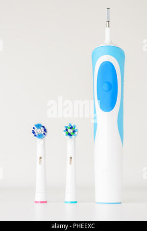 Modern electric toothbrush and spare heads on white background, close up Stock Photo