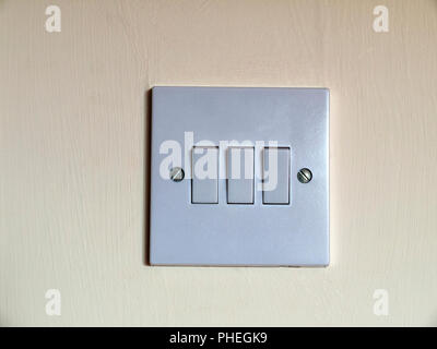 Close up of a build in wall triple light switch Stock Photo