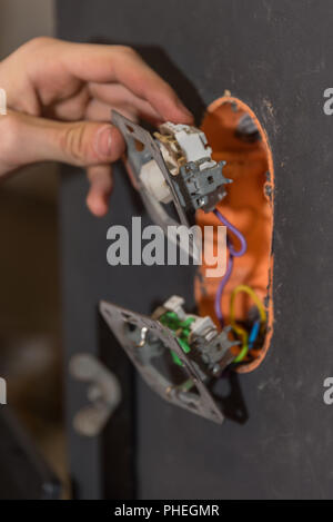 Installing electrical circuits on a wall - close-up Stock Photo