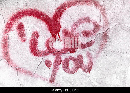 Cracked red heart on concrete wall Stock Photo