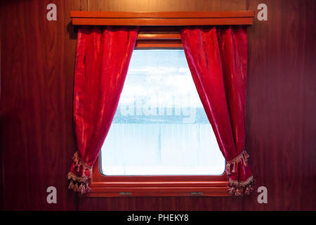 Red curtains on the window Stock Photo