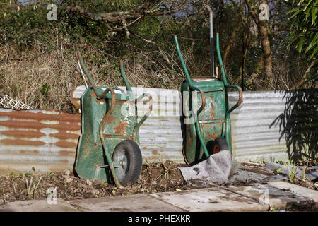 Old wheelbarrows in an allotment Stock Photo