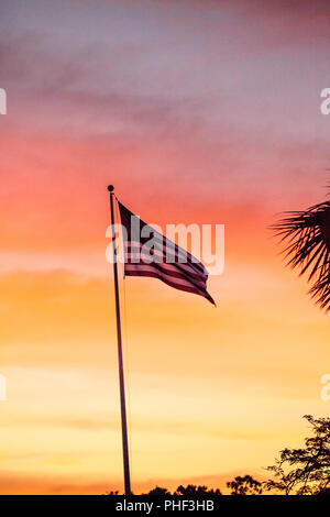 American flag blows in the wind  at sunrise Stock Photo