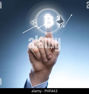 the man clicks Icon Bitcoin on virtual screen. Stock Photo