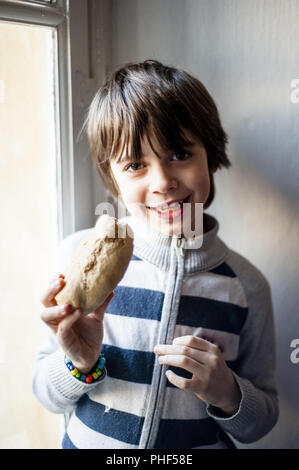 child eats big homemade bread Stock Photo