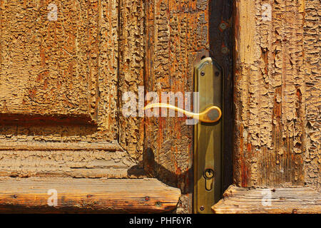 doorknob detail on old door, textural weathered wood Stock Photo