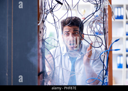 Electrician trying to untangle wires in repair concept Stock Photo