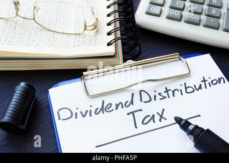 Dividend Distribution Tax DDT written on a sheet of paper. Stock Photo