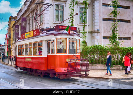Lisbon, Portugal - March 29, 2018: Red tourist tram, symbol of Lisbon and downtown street Stock Photo