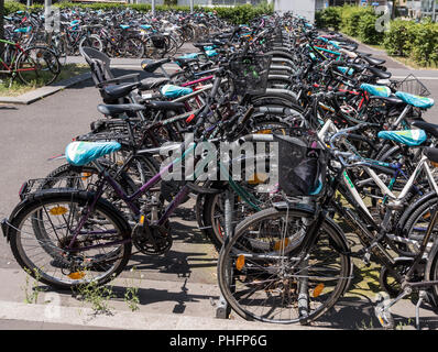 many bicycles in the city in a parking lot Stock Photo