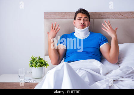 Young man with neck injury in the bed Stock Photo