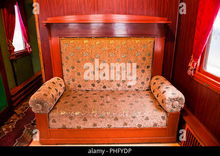 Vintage old sofa in the compartment interior Stock Photo
