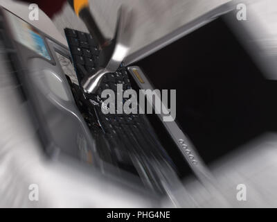 Computer laptop being smashed and destroyed with a hammer Stock Photo