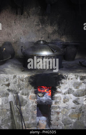 An old stone stove with an old saucepan. China Stock Photo