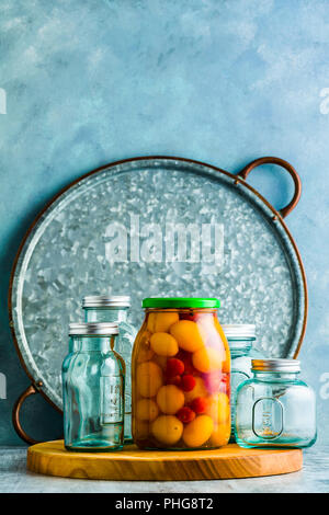 Preserved vegetables on wooden background Stock Photo