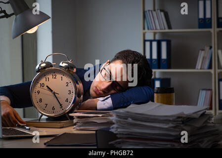 Businessman falling asleep during long hours in office Stock Photo