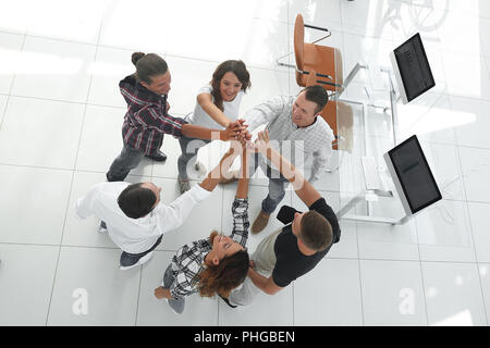 creative team giving each other a high five Stock Photo