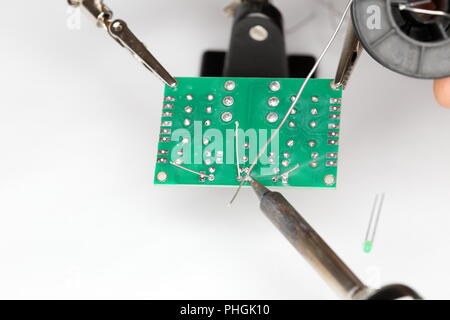soldering a green card Stock Photo