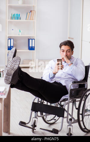 Doctor resting on wheelchair in hospital after night shift Stock Photo