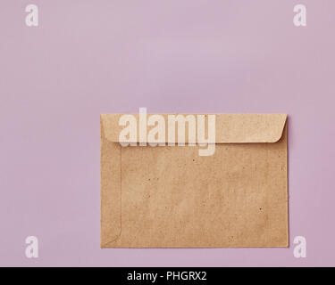 Brown craft envelope isolated on pink background Stock Photo