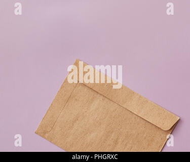Brown craft envelope for mailing on pink background Stock Photo