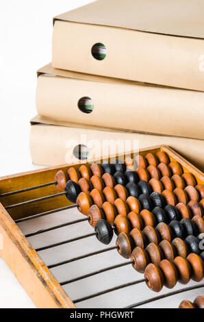 Old abacus and folders with documents, close-up Stock Photo