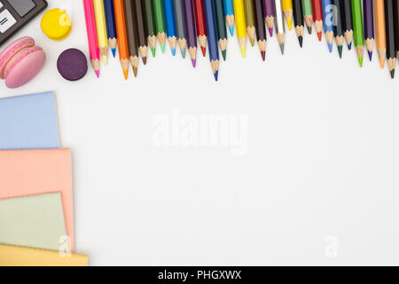 Top view of open  sketchbook with colored pencils on white background. Stock Photo