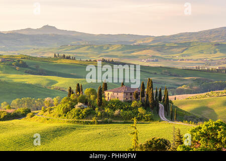 Farm house on a hill in Tuscany landscape Stock Photo