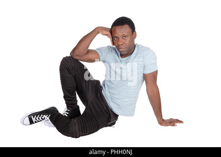 Handsome African man sitting on floor resting Stock Photo