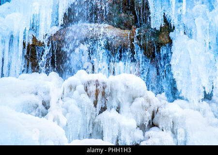 Frozen waterfall of blue icicles Stock Photo