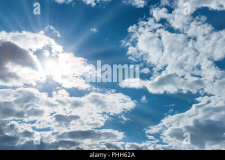 Sun shining through white clouds Stock Photo
