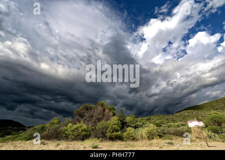 storm clouds forming in the mountains and extending to the coast Stock Photo