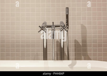 Interior and design of the modern toilet and bathroom, items in the bathroom hairdryer, mirror, bathrobe, bath, sink, water taps Stock Photo